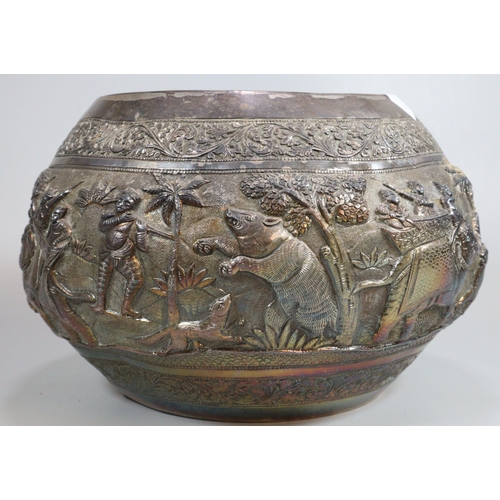 276 - Indian/Burmese circular bowl, chased in bold relief with a hunting party under attack with various a... 