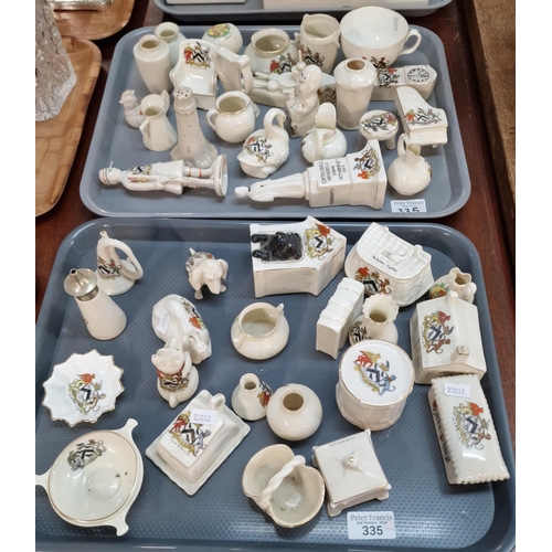 335 - Two trays of various' Llandilo' crested ware to include: battleship, rifleman, barrel, long cased cl... 