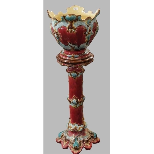 58 - Art Nouveau Majolica ruby and turquoise ground jardinière on stand. 130cm high approx.  (B.P. 21% + ... 