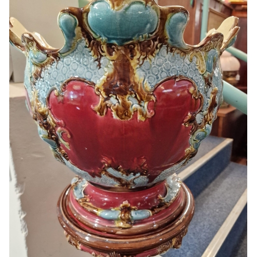 58 - Art Nouveau Majolica ruby and turquoise ground jardinière on stand. 130cm high approx.  (B.P. 21% + ... 