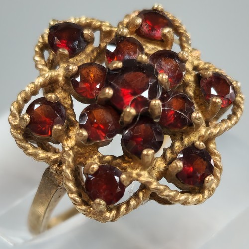 198 - 9ct gold garnet multi cluster flowerhead ring. 4.1g approx. Size K. (B.P. 21% + VAT)