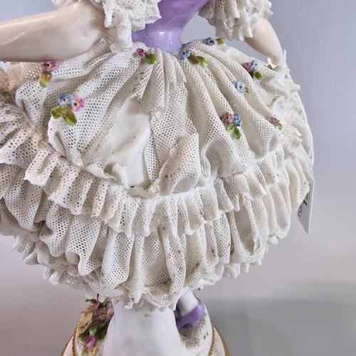 13 - Three Continental porcelain figurines of ballet dancers with encrusted dresses and flowers (3) The t... 