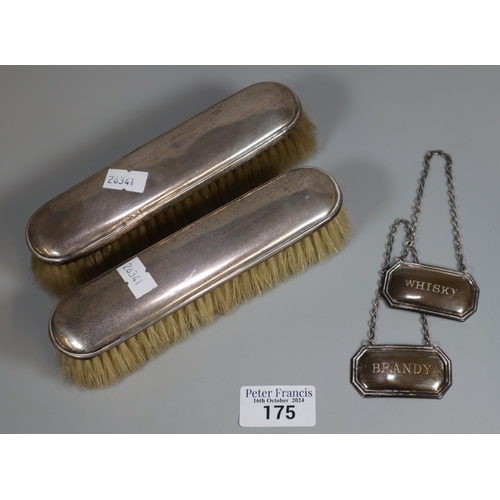 175 - Two silver topped ladies' hairbrushes together with two silver spirit decanter labels marked Brandy ... 