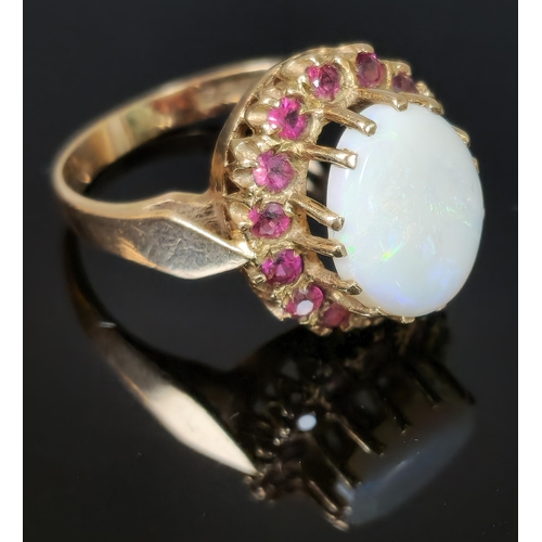 194 - 9ct gold opal and red stone cluster ring. 4.8g approx. Ring size P. (B.P. 21% + VAT)