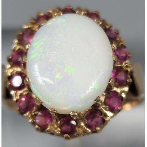 194 - 9ct gold opal and red stone cluster ring. 4.8g approx. Ring size P. (B.P. 21% + VAT)