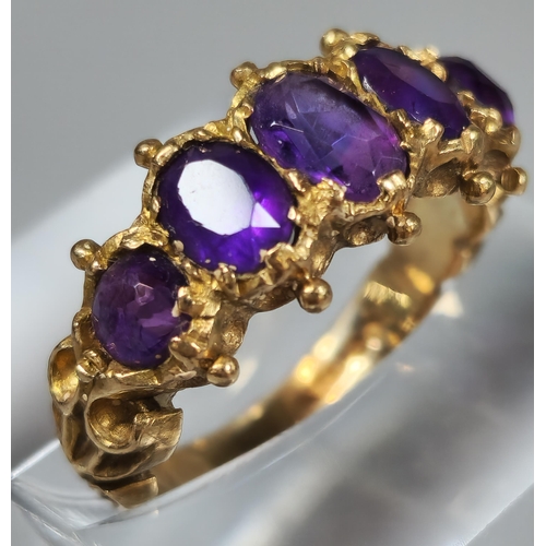 197 - 9ct gold five stone purple dress ring. 3.1g approx. Ring size J. (B.P. 21% + VAT)