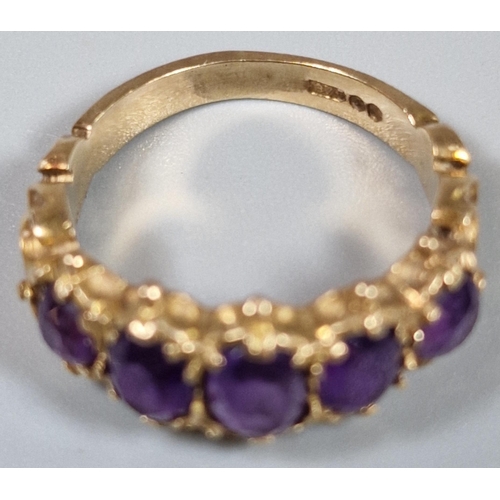 197 - 9ct gold five stone purple dress ring. 3.1g approx. Ring size J. (B.P. 21% + VAT)