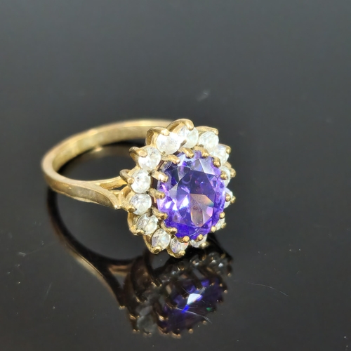 199 - 9ct gold purple and clear stone cluster ring. 4.3g approx. Ring size L 1/2. (B.P. 21% + VAT)