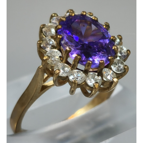 199 - 9ct gold purple and clear stone cluster ring. 4.3g approx. Ring size L 1/2. (B.P. 21% + VAT)