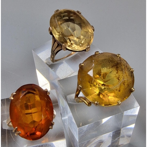 203 - Three 9ct gold dress rings inset with orange and yellow stones. 20g approx. Ring sizes P 1/2, M 1/2 ... 