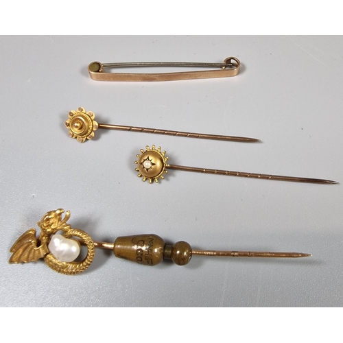 206 - Two Edwardian flowerhead stick pins. 1.4g approx. Together with another stick pin marked 14K and a 9... 