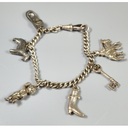 208 - A silver charm bracelet, the charms to include: terrier dog, shoe, boot, key, etc. (B.P. 21% + VAT)