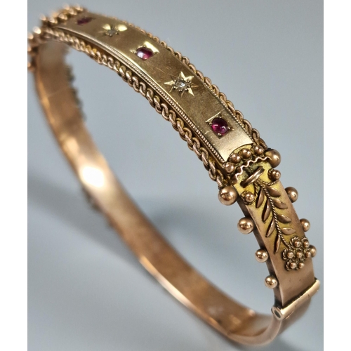 210 - 9ct rose gold diamond and ruby ladies' bangle. 11g approx. (B.P. 21% + VAT)