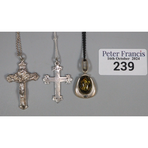 239 - Collection of chains and pendants to include two crucifix and one amber, the three in silver. (B.P. ... 