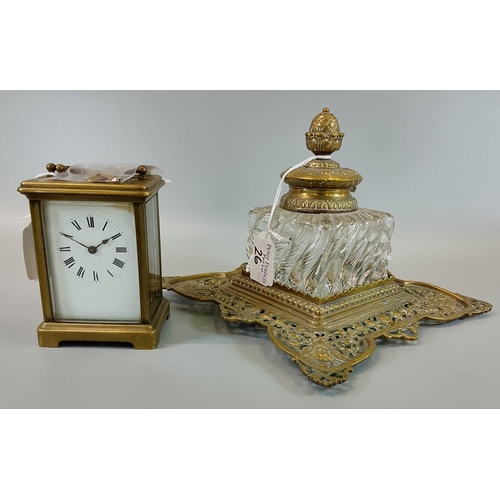 26 - An early 20th century brass carriage clock with key together with a Victorian style brass and glass ... 