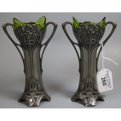 260 - A pair of Art Nouveau pewter Epergne two-handled vases with green glass liners. Unmarked. Height app... 