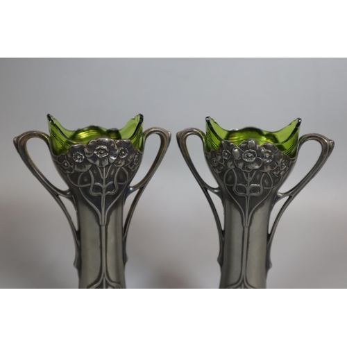 260 - A pair of Art Nouveau pewter Epergne two-handled vases with green glass liners. Unmarked. Height app... 