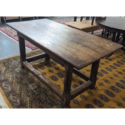 450 - 17th century style rustic oak table, the moulded top above shaped chamfered legs and stretchers. 151... 