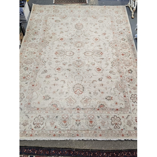 486 - Large Middle Eastern design cream ground floral and foliate carpet. 342 x 246cm approx. Together wit... 