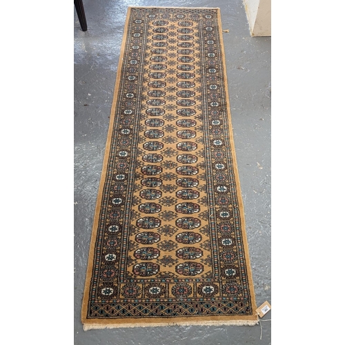 489 - Gold ground Pakistan Bokhara runner. 242 x 75cm approx. (B.P. 21% + VAT)