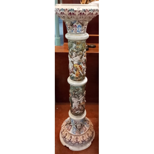 67 - 20th century Capodimonte ceramic jardinière stand depicting relief nude figures and other decoration... 