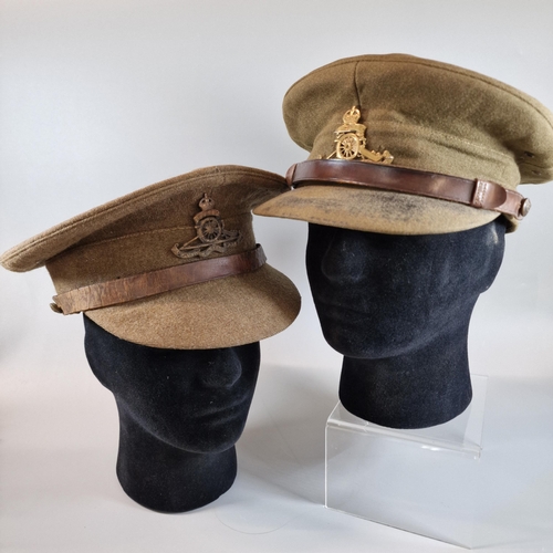 19 - Two WWI period Officer's caps with cap badges for Royal Artillery. (2) (Mannequin head for display o... 