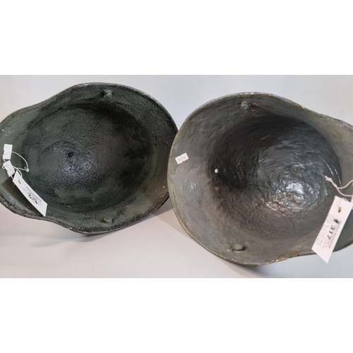 317 - Two German WWI M16 Stahlhelm / helmets. Later painted with camouflaged scheme. (2) (B.P. 21% + VAT)