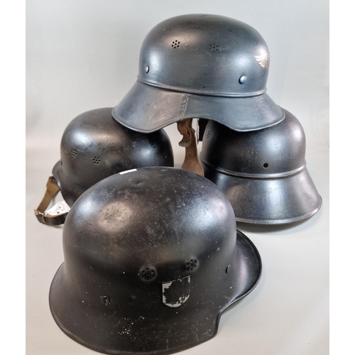 320 - Four German helmets to include: Two German Luftschutz M38 'Gladiator' helmets, one with liner. One G... 