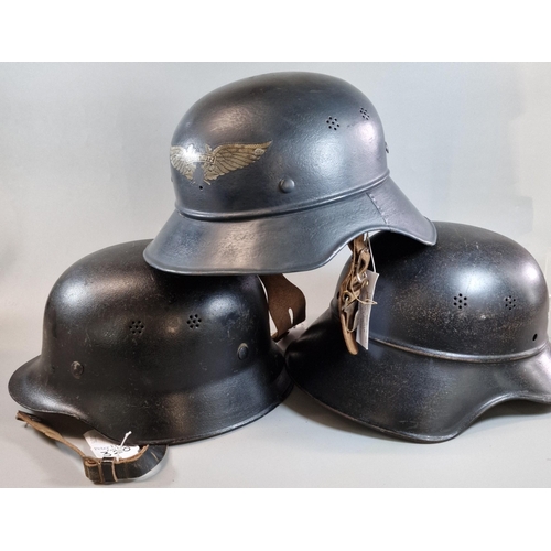 320 - Four German helmets to include: Two German Luftschutz M38 'Gladiator' helmets, one with liner. One G... 