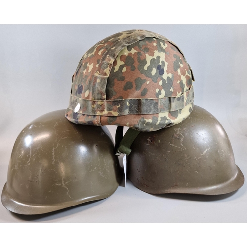 321 - Three helmets to include: one German Bundeswehr M-1A1 (M81) helmet with flecktarn cover and two poin... 