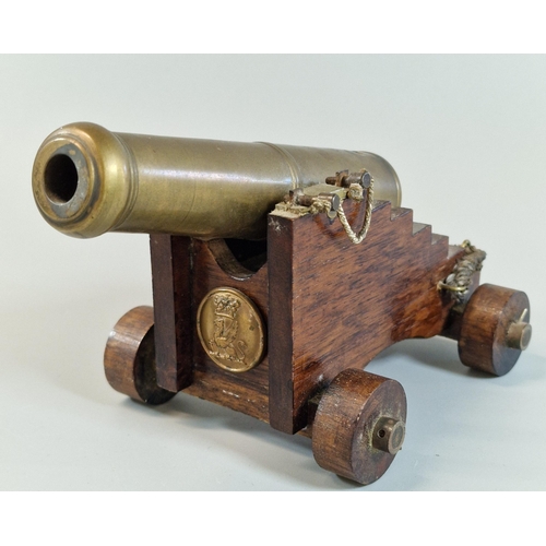 49 - Model of a brass barreled Naval cannon on wooden carriage marked with Crown over GR cypher. 18cm lon... 