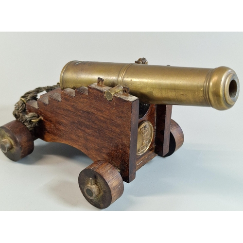 49 - Model of a brass barreled Naval cannon on wooden carriage marked with Crown over GR cypher. 18cm lon... 