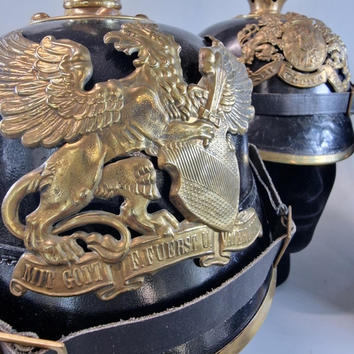 54 - Group of three reproduction Imperial German Pickelhaube leather and brass mounted Officer's dress he... 