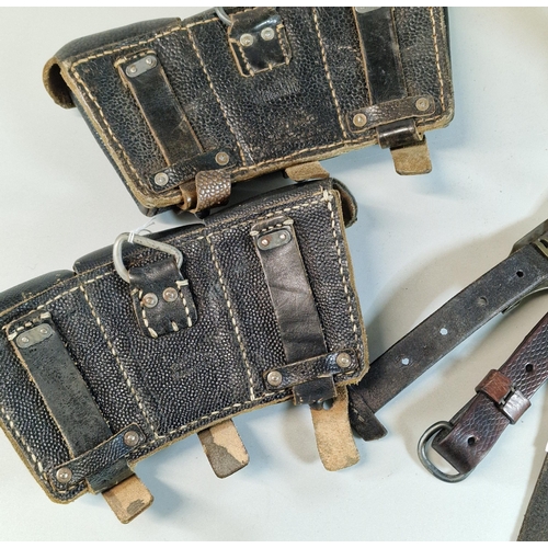 69 - Two German probably WWI three section ammunition pouches, together with a set of German metal mounte... 