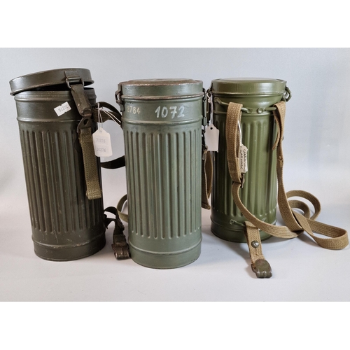 72 - Three German WWII period gas mask cylinders with  webbing straps. 28.5cm high approx. (3)  (B.P. 21%... 