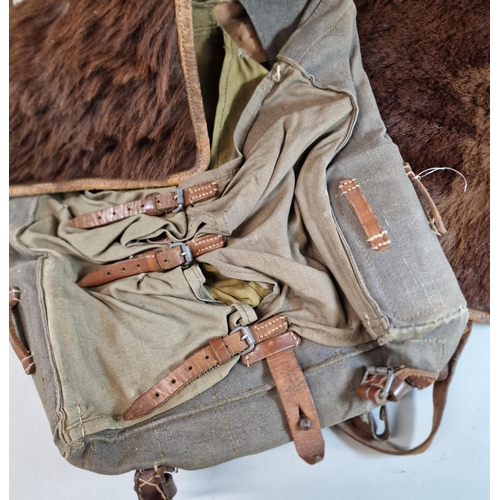 82 - German WWII period Turnister fur covered canvas knapsack, together with another similar bearing Red ... 