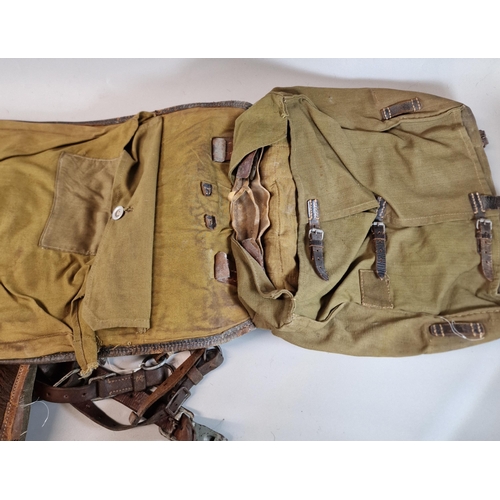 82 - German WWII period Turnister fur covered canvas knapsack, together with another similar bearing Red ... 