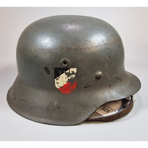 325 - German M42 helmet WWII period. Marked 'EF64' and '473'. With chinstrap and liner. (B.P. 21% + VAT)