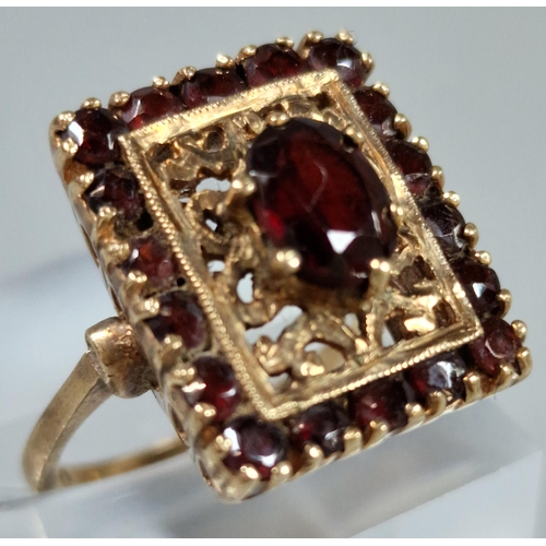 187 - 9ct gold and garnet dress ring. 5.9g approx. Ring size L 1/2. (B.P. 21% + VAT)