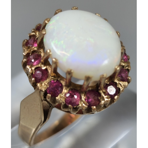 194 - 9ct gold opal and red stone cluster ring. 4.8g approx. Ring size P. (B.P. 21% + VAT)