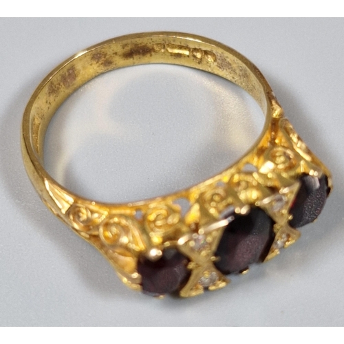 198 - 9ct gold three stone garnet and diamond dress ring. 4.3g approx. Ring size O 1/2. (B.P. 21% + VAT)