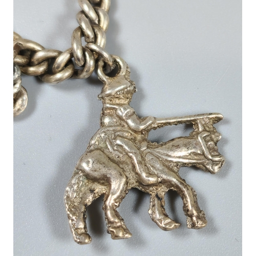 208 - A silver charm bracelet, the charms to include: terrier dog, shoe, boot, key, etc. (B.P. 21% + VAT)