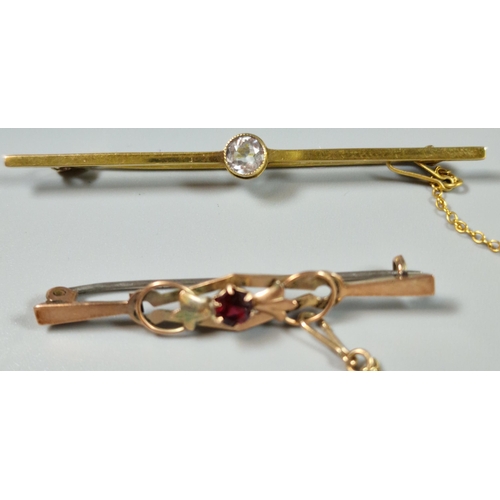 215 - Edwardian 9ct gold and ruby bar brooch. 1.6g approx. Together with another 9ct gold and blue stone b... 