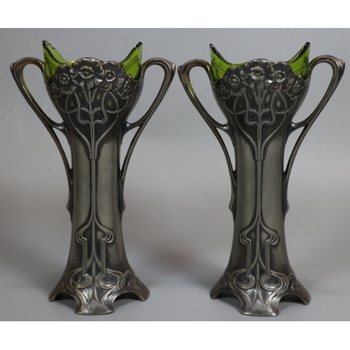 260 - A pair of Art Nouveau pewter Epergne two-handled vases with green glass liners. Unmarked. Height app... 