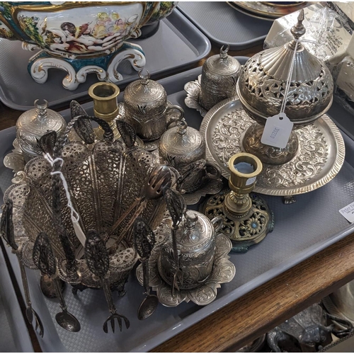 307 - A tray of metalware to include: set of silver-plated Persian design cups and saucers with porcelain ... 