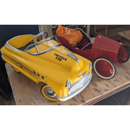 393 - Two reproduction metal pedal cars to include checker cab and another in partly dismantled state. (2)... 