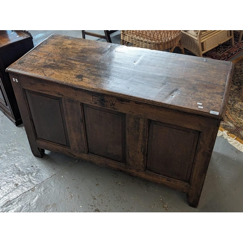 409 - 18th century oak coffer, the moulded and hinged top with fitted candle box to the interior. Carved i... 