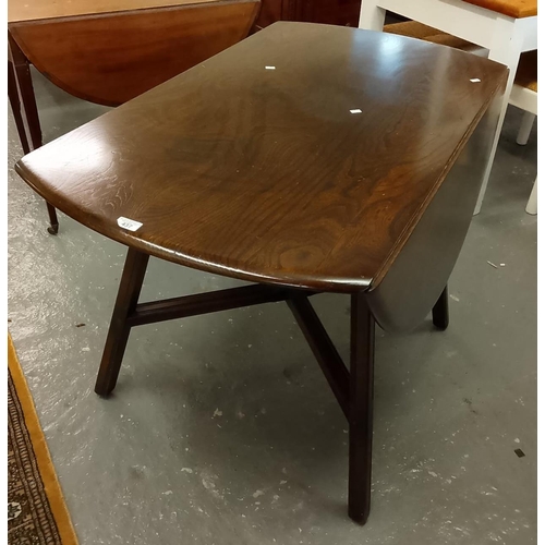 437 - Mid-century elm Ercol drop-leaf table on X frame supports. (B.P. 21% + VAT)