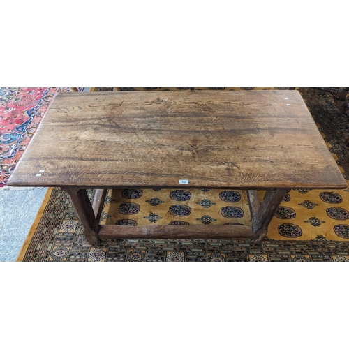 450 - 17th century style rustic oak table, the moulded top above shaped chamfered legs and stretchers. 151... 