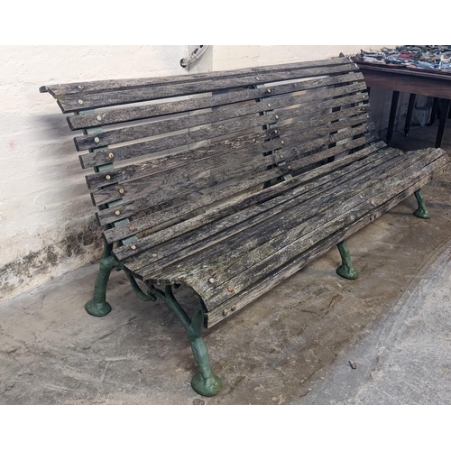 466 - Slatted wooden garden bench with three part cast iron underframe. 182cm wide approx. (B.P. 21% + VAT... 